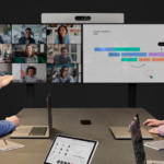 A member of an hybrid event is lively interacting via online with his four colleagues who work remotely.